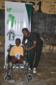 IAF beneficiary, Godknows Atata and IAF Education Ambassador, Vincent Adeoba at the wheelchair donation to Godknows Atata