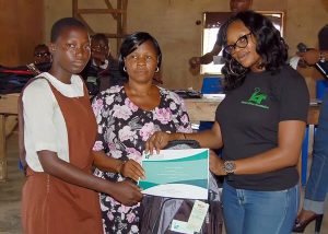 The IAF Operations Executive and a teacher of the Aglican Grammar School presenting a scholarship award of outstanding performance to a student