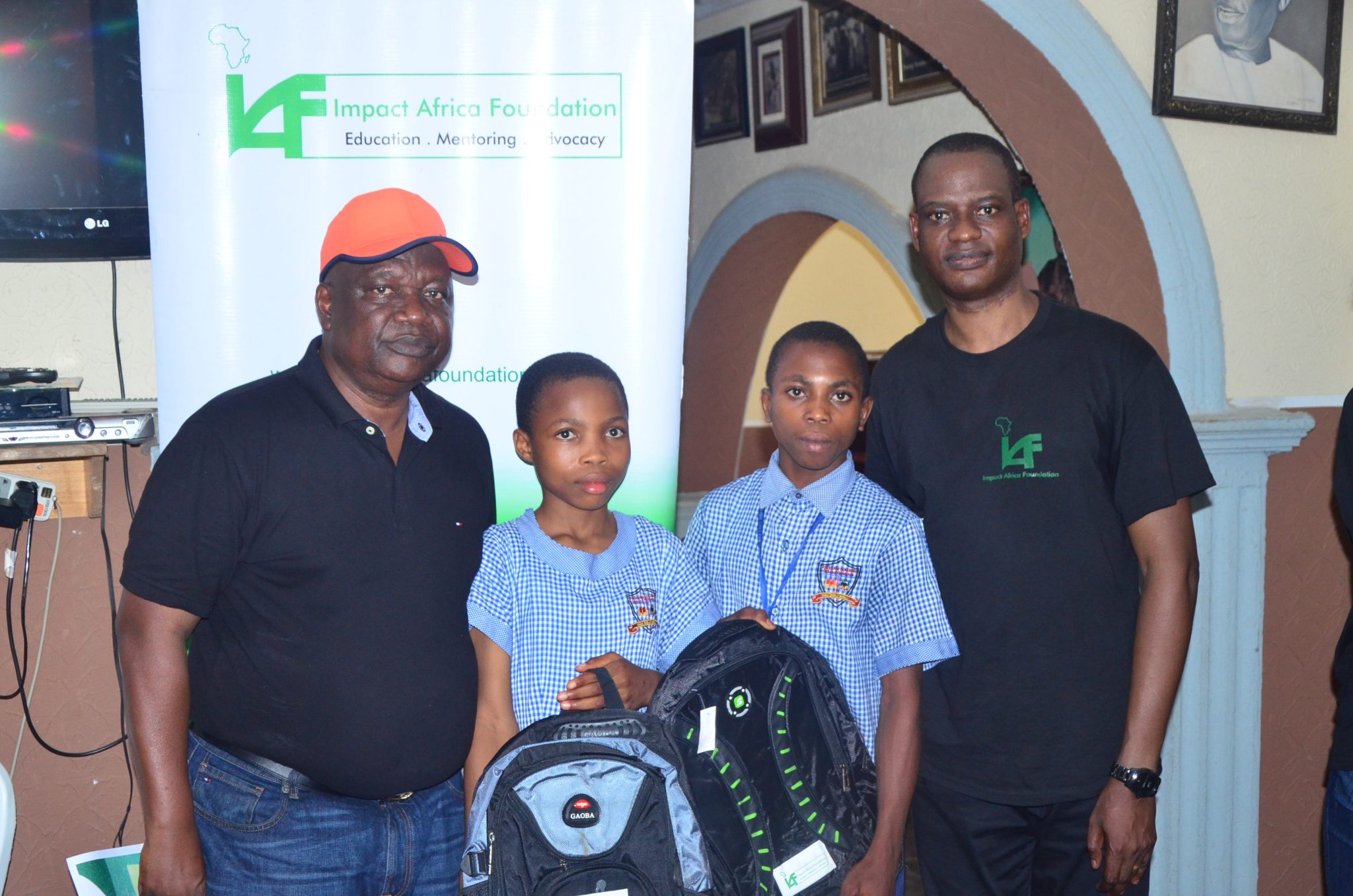 Taiwo Oyedele with senior prefects carrying school bags donated by IAF to Abolarin College