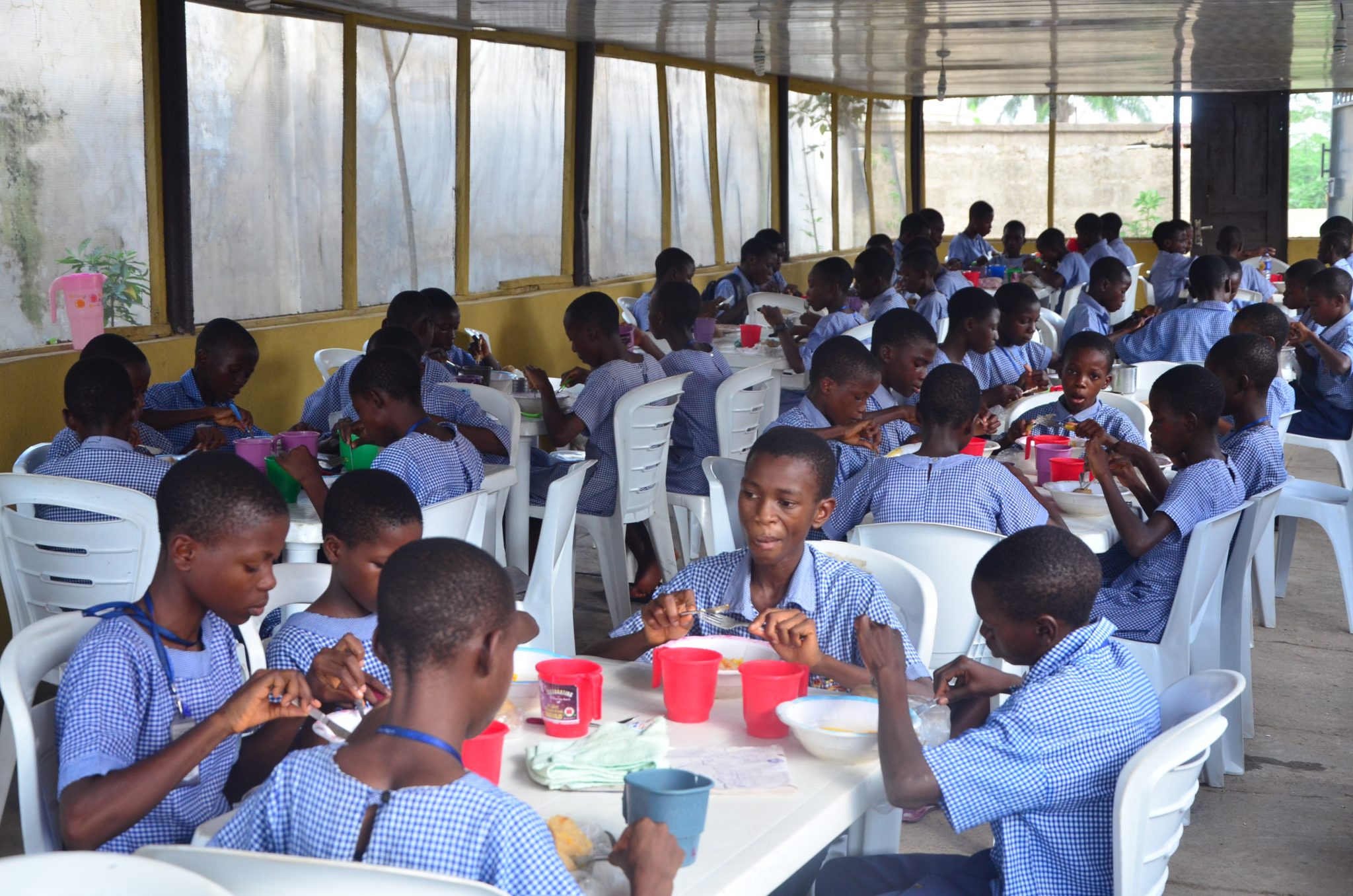 Students enjoying their free daily meal at Abolarin College